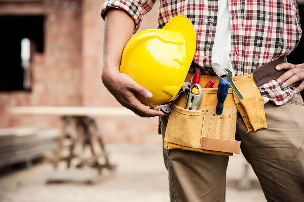 Construction worker on building site protected by commercial insurance